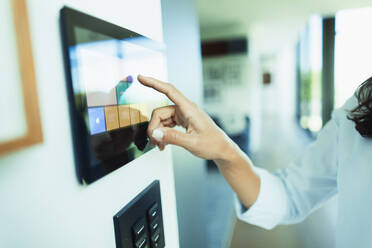 close-up-woman-at-home-automation-touch-screen-panel-HOXF05550 close-up-woman-at-home-automation-touch-screen-panel-HOXF05550